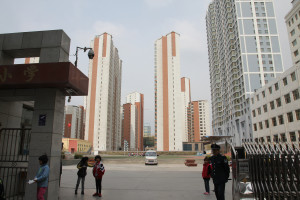 A school yard surround by apartment towers. Security at schools has been tightened after a number of attacks. This school had armed guards and crash resistant barriers. Xining, Qinghai province, Western China
